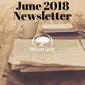June 2018 newsletter cover with coffee and papers on a wooden table.