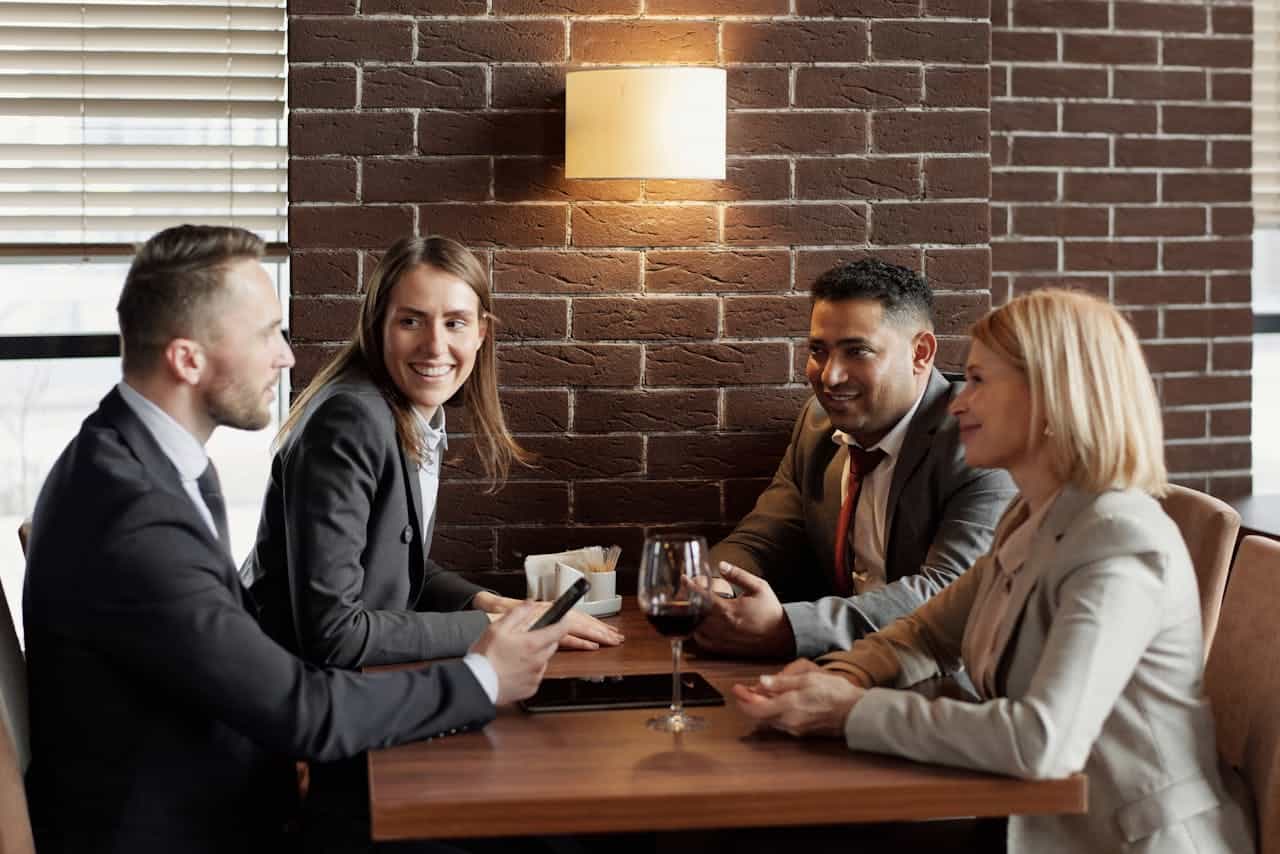 Business professionals engaging in a conversation at a table.