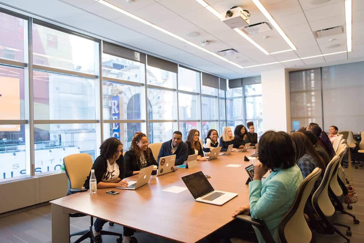 Team meeting in a modern conference room with large windows.
