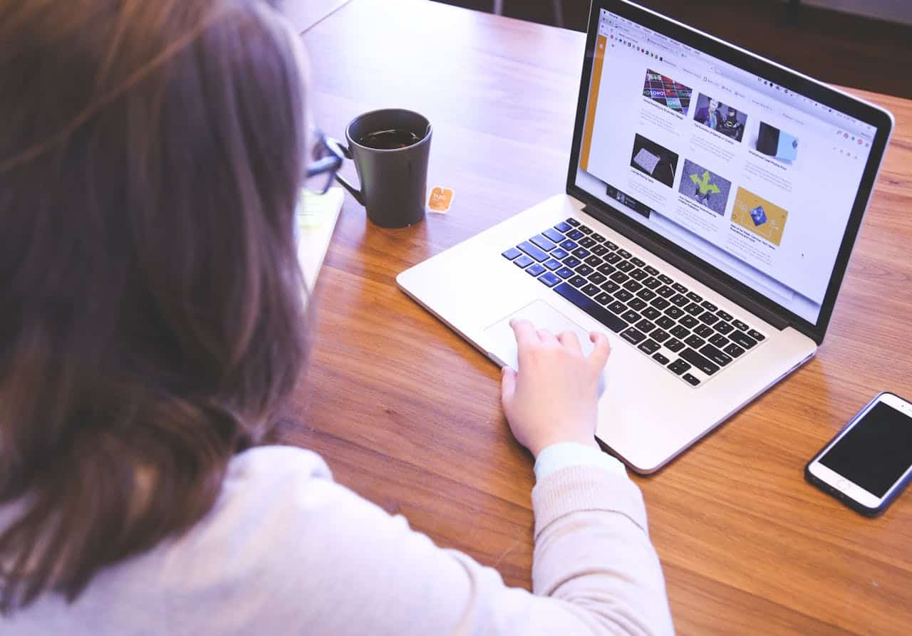 Laptop screen displaying a website with various images and articles.